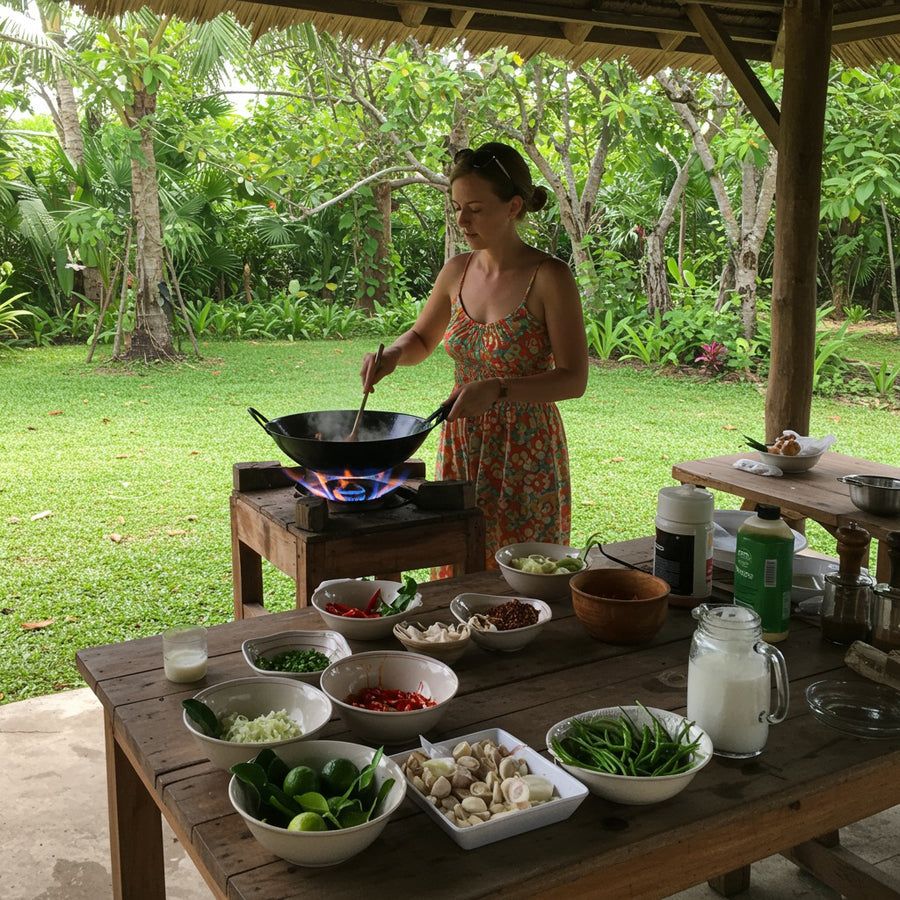 Thai cooking class student cooking at a wok over a flame in Koh Samui